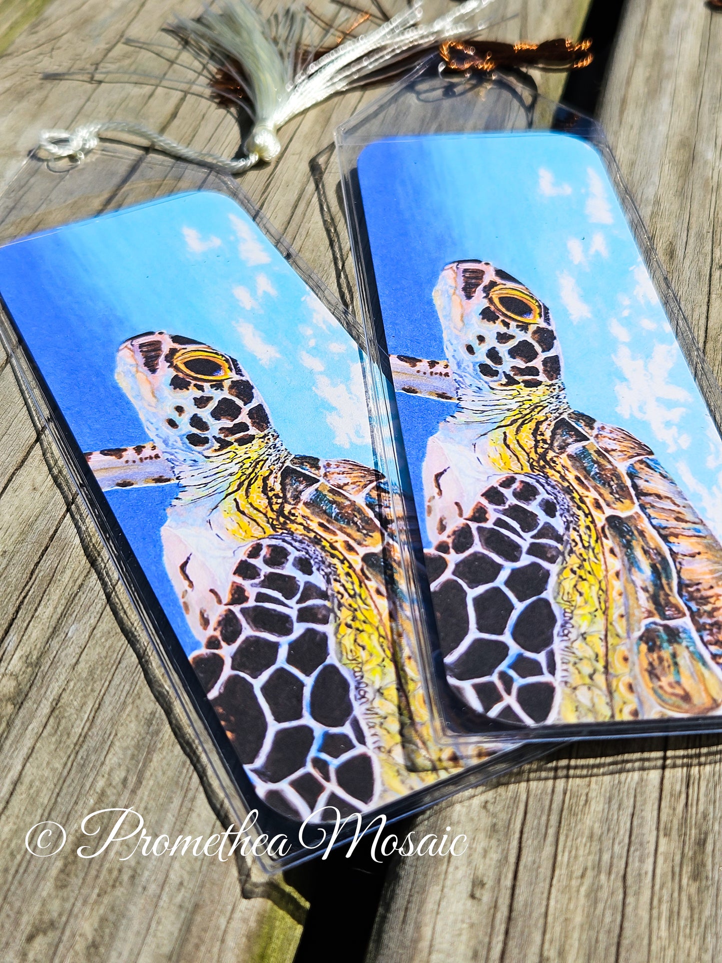 Closeup detail of watercolor like artwork of sea turtle bookmark with case and decorative tassel