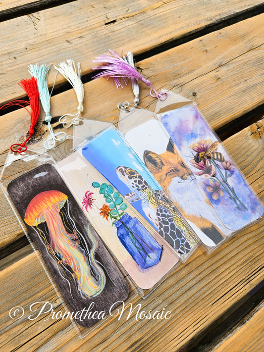 Set of 5 eco-friendly bookmarks featuring art of a neon jellyfish with black background, a blue vase holding wildflowers, a sea turtle swimming peacefully, a thoughtful orange fox, and a patient honeybee on flowers.