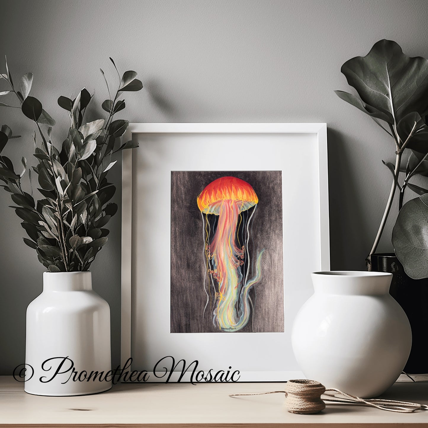 Framed jellyfish art print displayed on a shelf with white vases and plants, eco friendly ocean theme wall decor illustration.