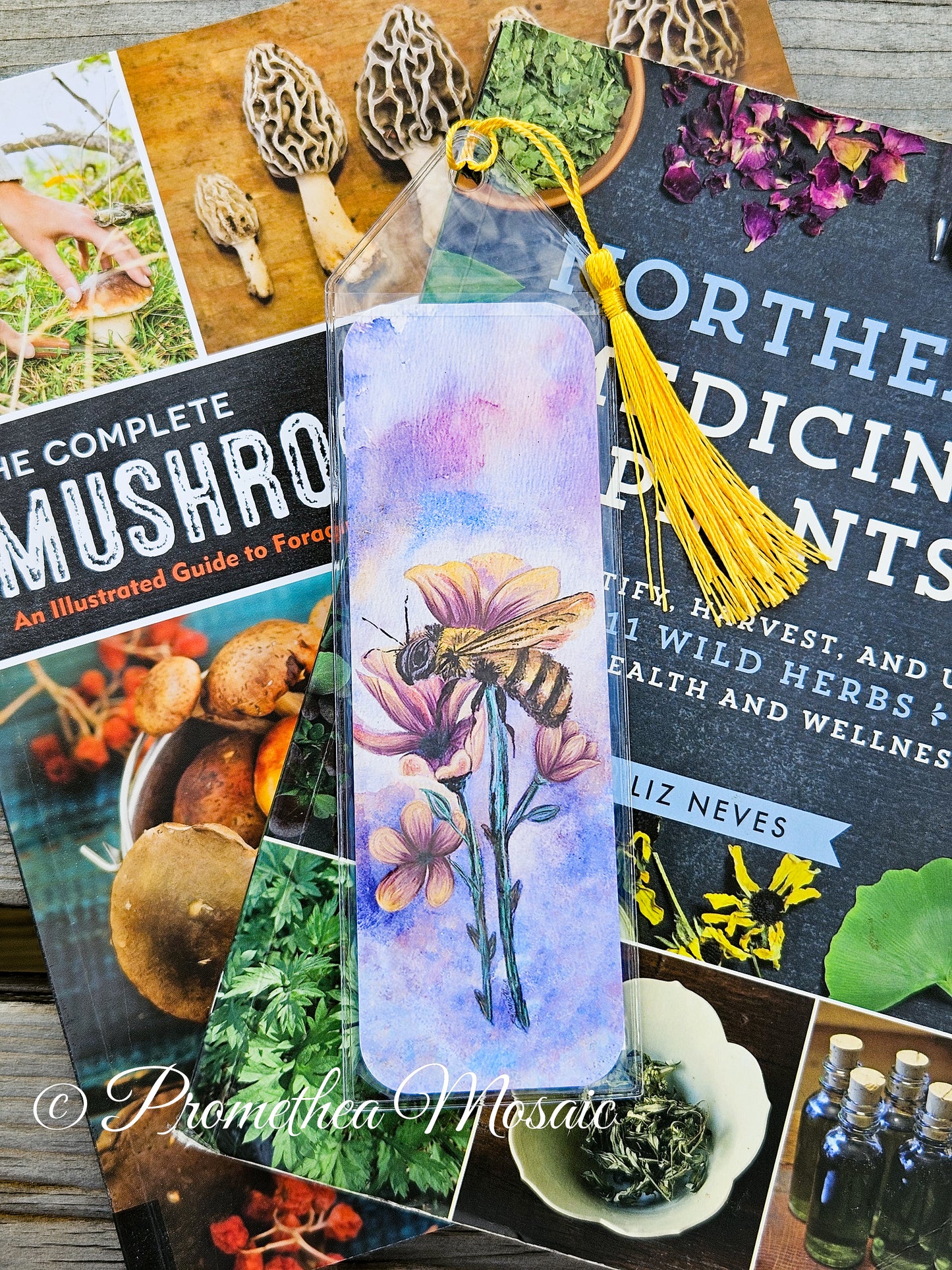 Honeybee with yellow flowers bookmark in reusable clear sleeve and tassel on a stack of books