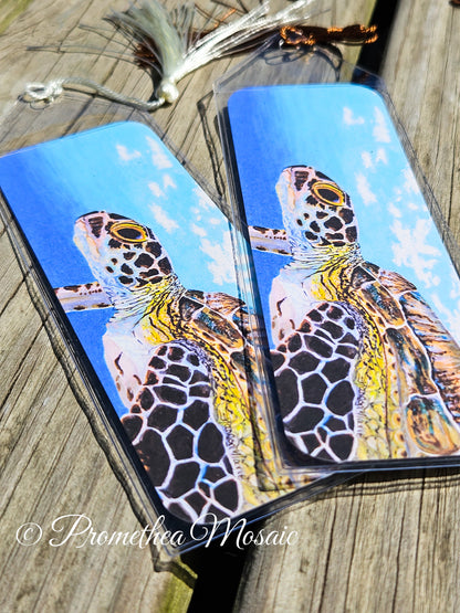 Closeup detail of watercolor like artwork of sea turtle bookmark with case and decorative tassel