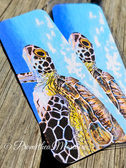 Detail painting like art of a sea turtle underwater on a bookmark.