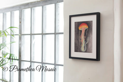 Framed artwork of a jellyfish on a wall next to a window with natural light.