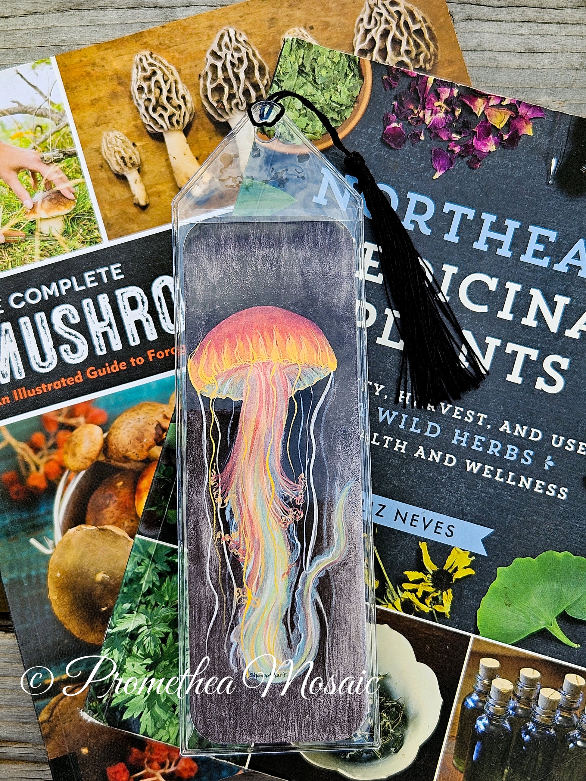 clear protective case holding eco-friendly bookmark with a brightly colored jellyfish watercolor and gouache painting printed on it.